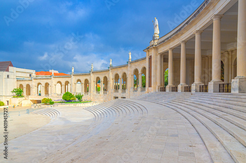 Sanctuary of Our Lady of Fatima with Basilica of Our Lady of the Rosary catholic church with stairs, colonnade with columns and statues of saints in Fatima town, Portugal