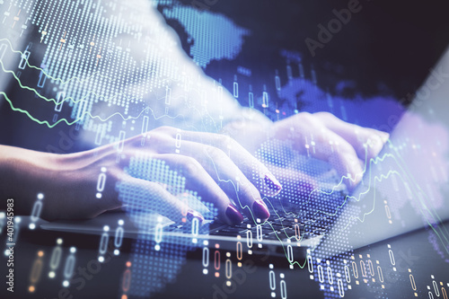 Double exposure of businesswoman hands typing on computer and forex chart hologram drawing. Financial analysis concept.