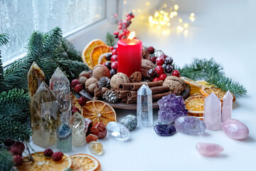 Gemstones crystals, candle and natural winter decor. Witchcraft Ritual, energy healing minerals. Esoteric, relax, life balance concept. Christmas, Magical Winter Solstice