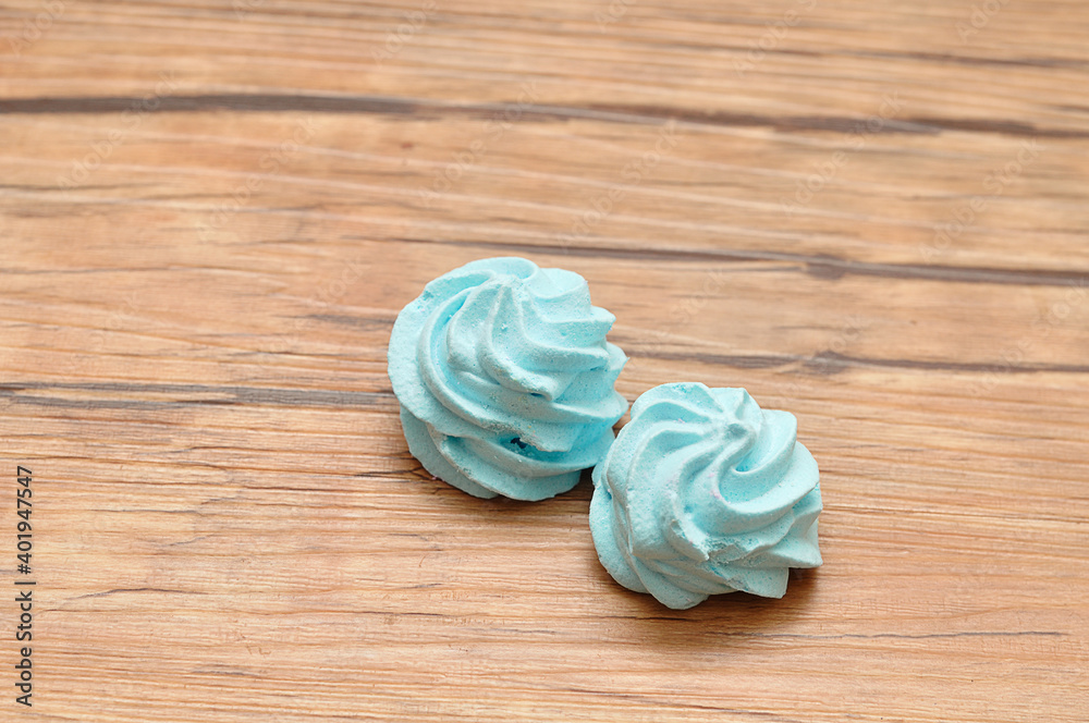 Two blue meringues on a table
