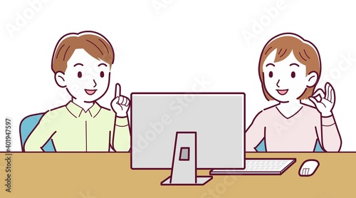 Two people talking while looking at a desktop computer