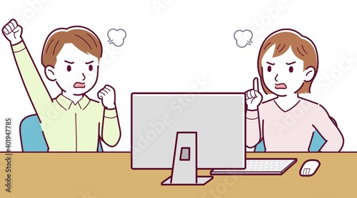 Two people talking while looking at a desktop computer