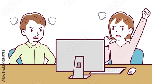 Two people talking while looking at a desktop computer
