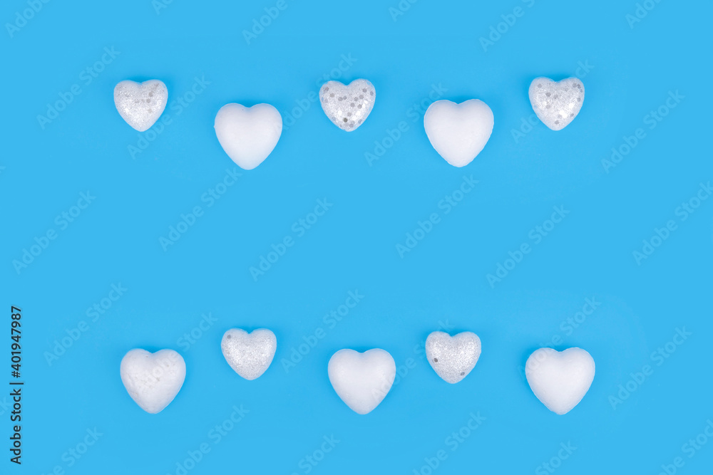 Minimal composition with white hearts on pastel blue background. Valentines day concept.