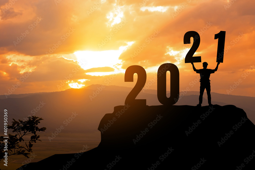 Silhouette freedom man holding number 2,1 on peaks with New year 2021.2021 New year Success concept. Silhouette freedom man holding number 2,1 on peaks with New year 2021.2021 New year Success concept.