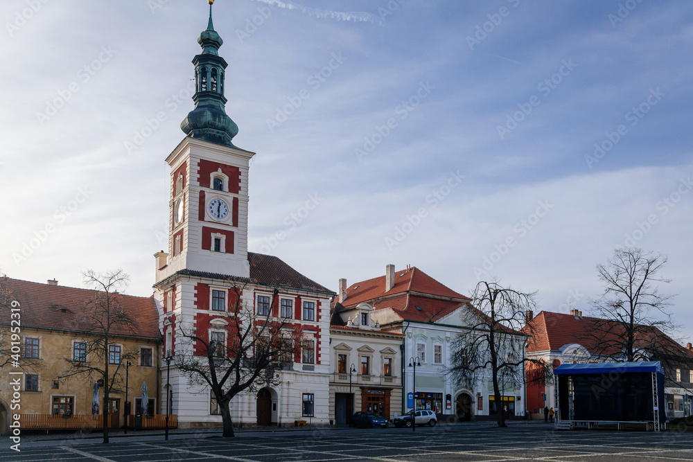 Obraz premium Old Town Hall with Clock Tower at the main Masaryk square of historic medieval royal town Slany, colorful renaissance houses in sunny winter day, Central Bohemia, Czech Republic
