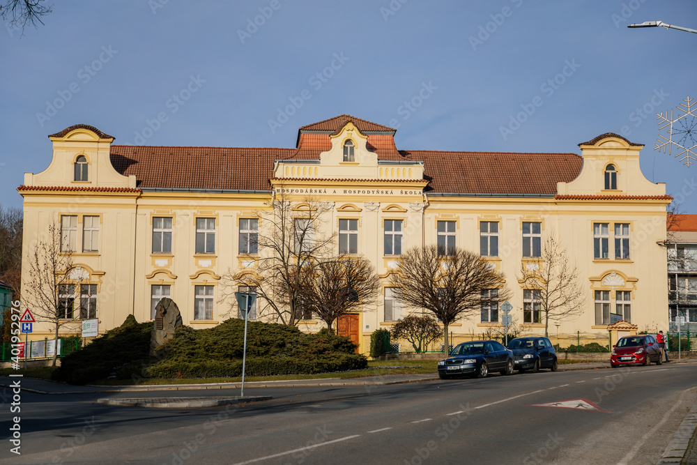 Yellow neo-renaissance house in sunny day, Secondary vocational school in historic center of medieval city Slany, Central Bohemia, Czech Republic