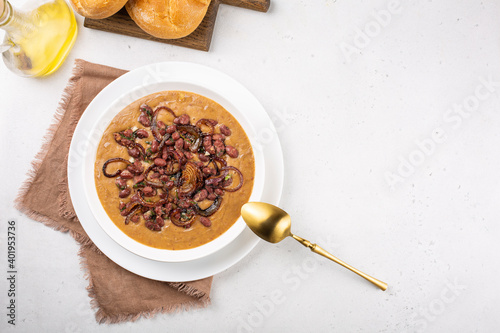 Vegan Red Kidney Bean Soup with caramelized onions  and herbs. Top view. Copy space. photo