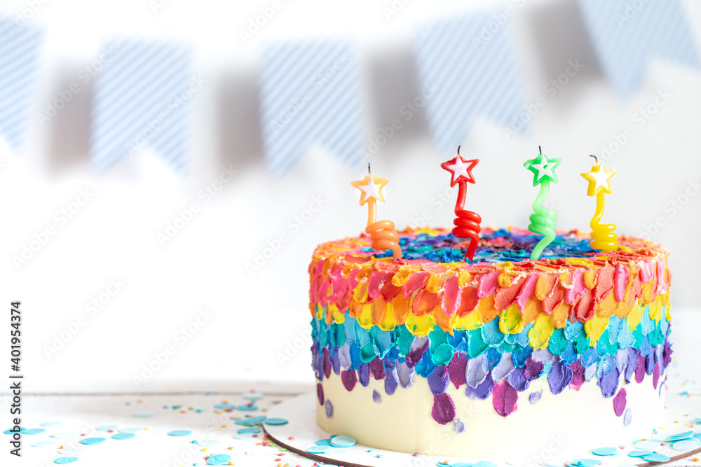 Obraz premium Handmade colorful big birthday cake with stars shaped candles.