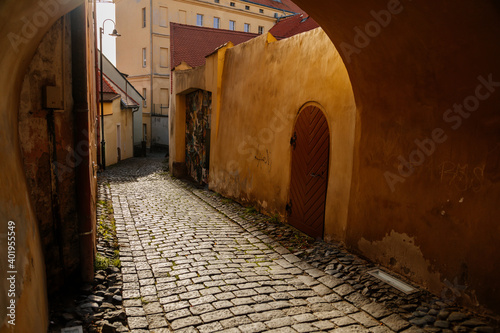 Narrow passageway, arched passage, picturesque street with colorful buildings in historic center, renaissance and gothic house, medieval city Slany, Central Bohemia, Czech Republic photo