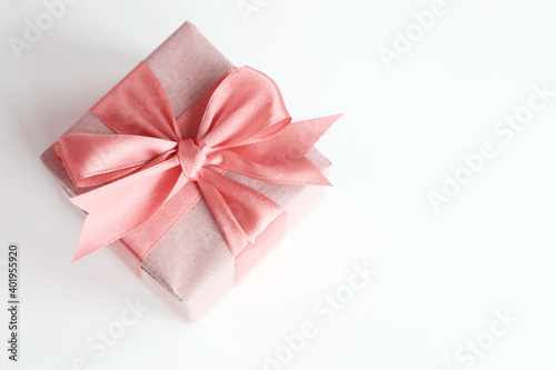 Brown paper gift box with beautiful satin ribbon, monochrome pink toned design, pastel colours. Universal gifts design for all kind of shopping and celebration