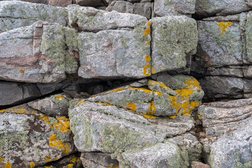 A closeup shot of the mossy rocks in the Island of Bornholm, Denmark in the daytime photo