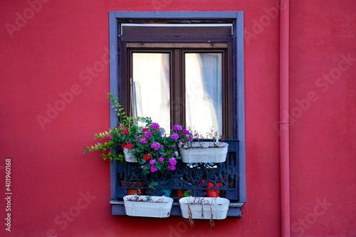 window on the red facade of the house, bilbao city architecture