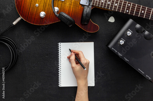 Desk of musician for songwriter work set with headphones and guitar