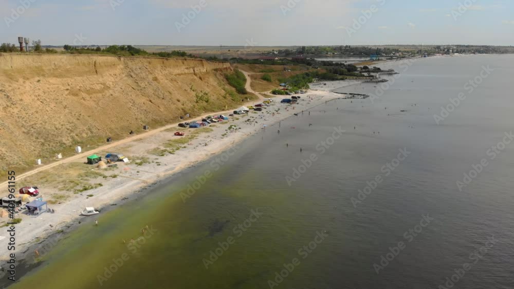 Wild ocean beach in harbour with free travelers in shore camping. Active and tourist lifestyle concept Wild ocean beach in harbour with free travelers in shore camping. Active and tourist lifestyle concept