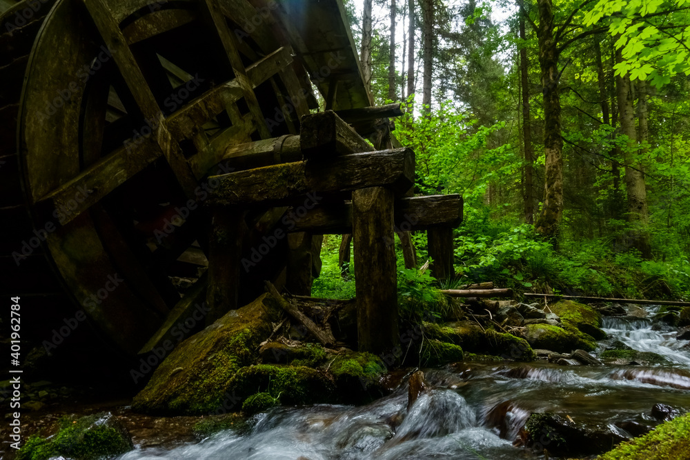 old water wheel from a mill with a fowing brook