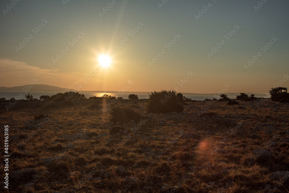 Sunset on adriatic island Pag with a dry plain.