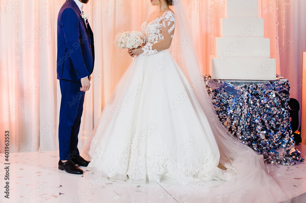 Fototapeta premium Bride and groom in a romantic moment edding ceremony. Cute young married couple.