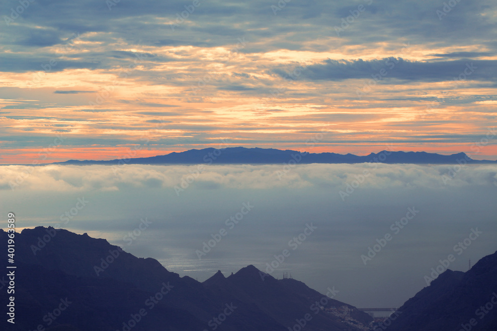 View at Gran Canaria island over the cloudy Atlantic ocean and the Anaga mountain range of Tenerife, Spain