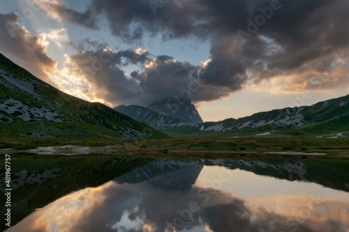 Lake with mountain reflection and clouds.