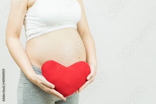 Wallpaper Mural pregnant woman holding red heart isolated on gray background-Motherhood, pregnancy, people and expectation concept. Torontodigital.ca