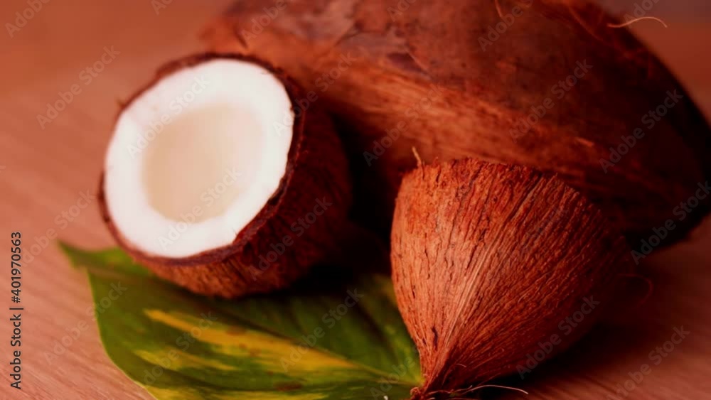 whole beach fruit,half coconut with green leaves wooden on background,hd footage of coconut milk and half coconut on wooden whole beach fruit,half coconut with green leaves wooden on background,hd footage of coconut milk and half coconut on wooden