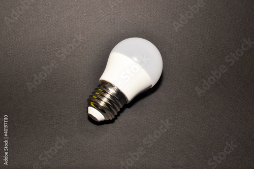 Led economy light bulb on black background space for text content