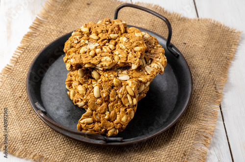 Peanuts brittle or peanuts chikki or gajak made with jaggery and roasted peanuts photo