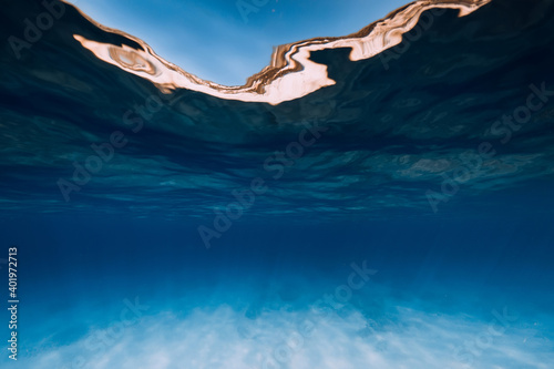 Tropical sea water in the deep with white sand bottom in underwater