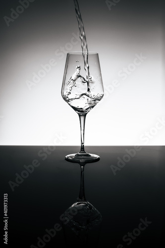 filling wine glass with sparkling water