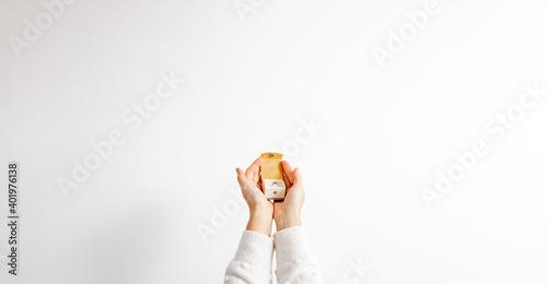 hands holding a yellow present box for the ring isolated on a white background.