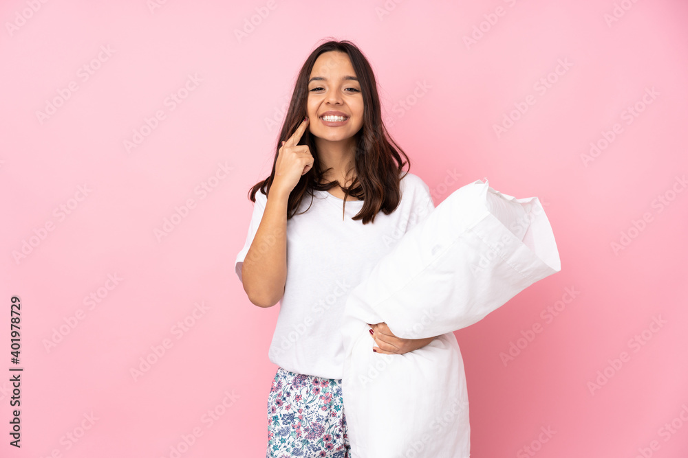 Young woman in pajamas isolated on pink background smiling with a happy and pleasant expression Young woman in pajamas isolated on pink background smiling with a happy and pleasant expression