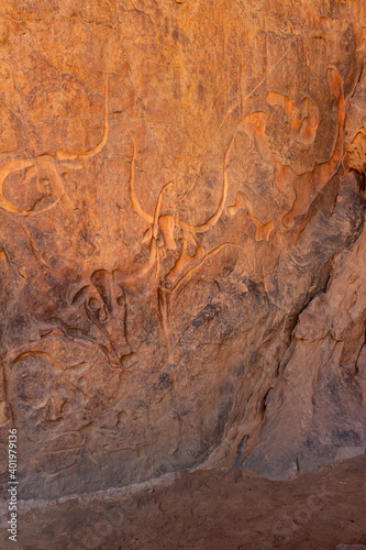 Famous rock relief carving of a crying cow at Tegharghart, near Djanet, Tassili nAjjer National Park, South Algeria, North Africa, 