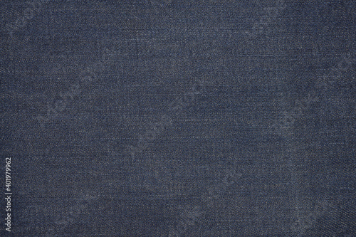 Denim texture in close up view with copy space for vintage background or wallpaper. Blue jeans pattern no seam with macro style to preset about classic fashion cloths concept. Indigo color fabric.