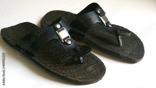 Sandals are made from recycled tires on white background.