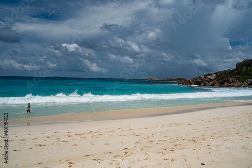 Fototapeta Naklejka Na Ścianę i Meble -  Seychelles La Digue Grand Anse South beach Indian ocean waves girl