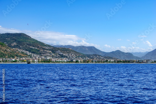 Mountain seascape with Alanya city on the coast - view from the Mediterranean Sea. Beautiful panorama of the Turkish resort town