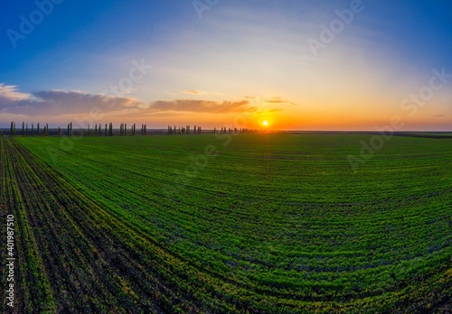 Flying over an green empty field