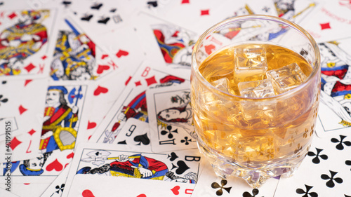 Gambling Card games for money. Playing cards as background. Poker, gambling and glass of alcohol