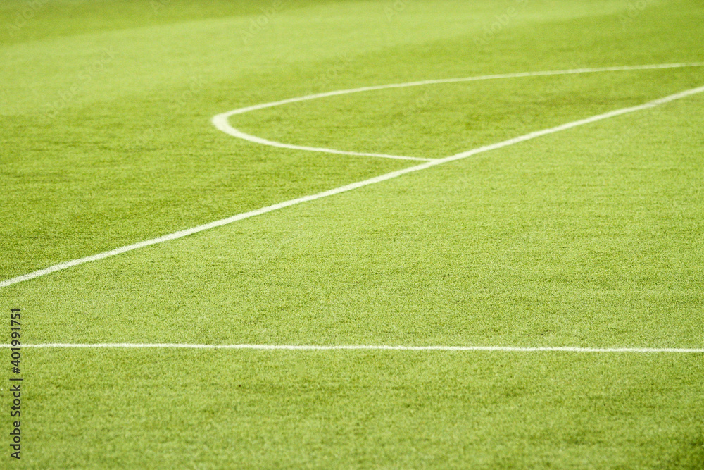 Large area of a football field, with its white lines, the half moon and the green of the synthetic grass. Large area of a football field, with its white lines, the half moon and the green of the synthetic grass.