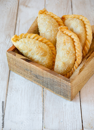 Fotografie Fried beef patties or pies inside wooden box on rustic white wooden table