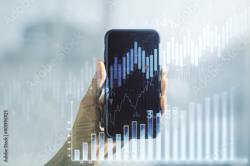 Abstract creative financial graph and hand with phone on background, forex and investment concept. Multiexposure © Pixels Hunter