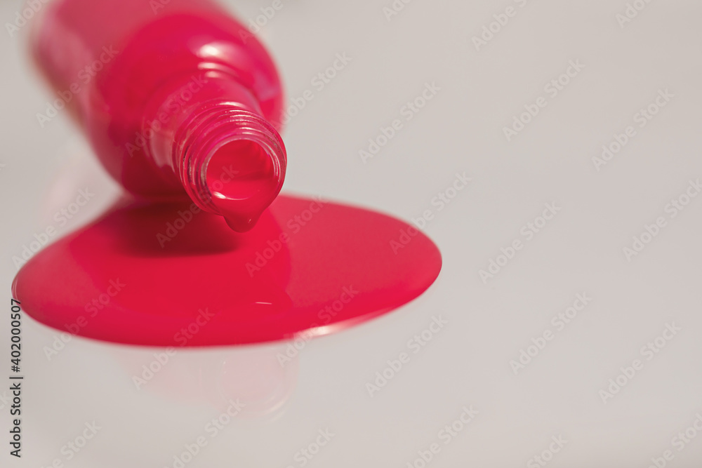 An inverted bottle of spilled nail polish. An inverted bottle of spilled nail polish.