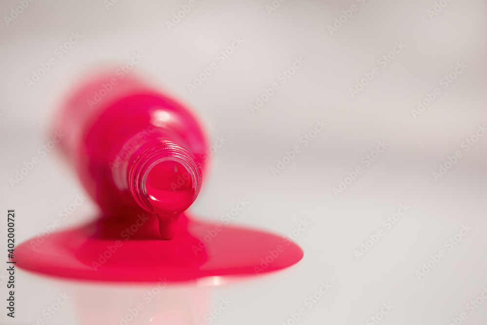An inverted bottle of spilled nail polish.