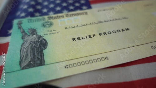 Blurring Stimulus check  relief program on Flag of USA, close up view. 