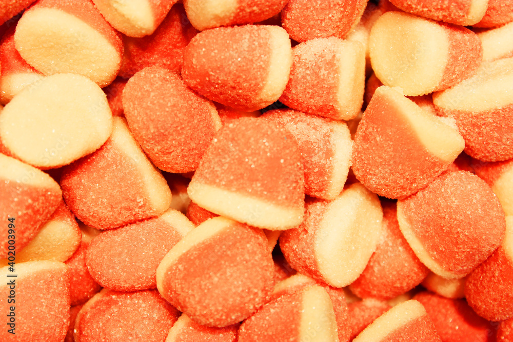 Candy A lot of sweets. Colorful texture using a background. Background rendering. Bright multiple jelly candies in powdered sugar. Confectionery wallpaper concept. Copy space. Shallow focus. Close-up Candy A lot of sweets. Colorful texture using a background. Background rendering. Bright multiple jelly candies in powdered sugar. Confectionery wallpaper concept. Copy space. Shallow focus. Close-up