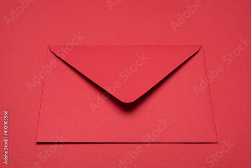 Close up view photo of bright red paper monochromatic envelope isolated vibrant color backdrop table