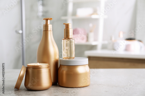 Different hair care products on table in bathroom © New Africa