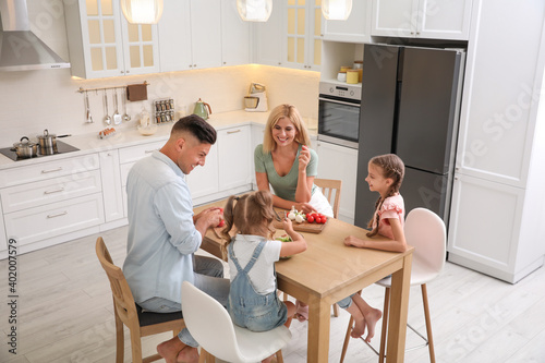 Happy family cooking together at table in modern kitchen