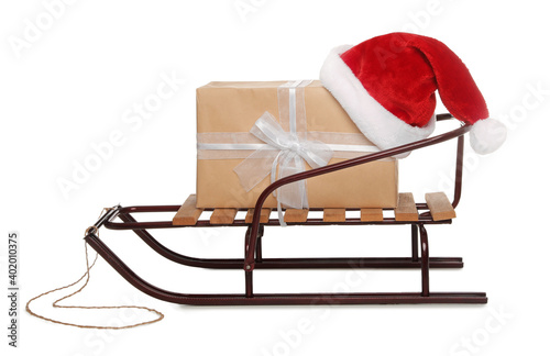 Sleigh with gift box and Santa hat isolated on white